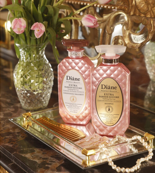 Extra Barrier Restore Conditioning Treatment and Shampoo on a mirrored tray with pink tulips
