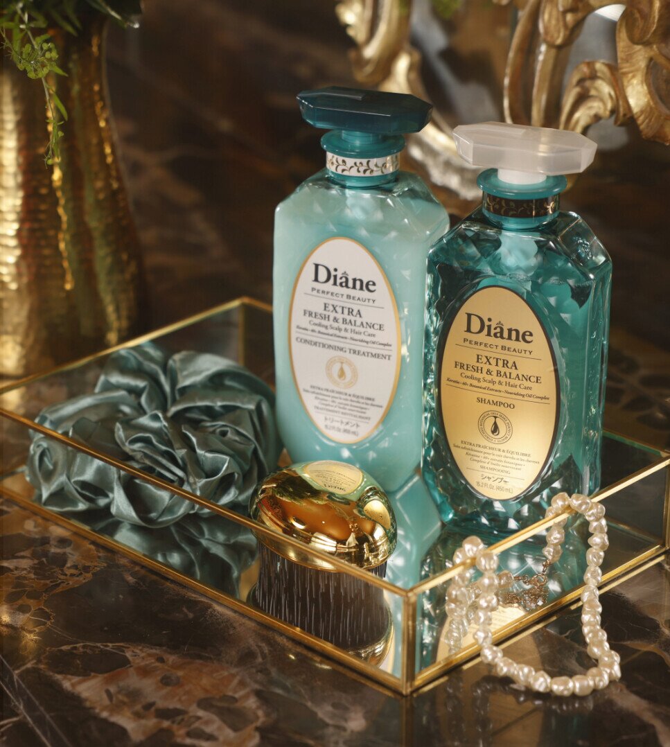 Extra Fresh & Balance Conditioning Treatment and Shampoo on a mirrored gold tray with pearls