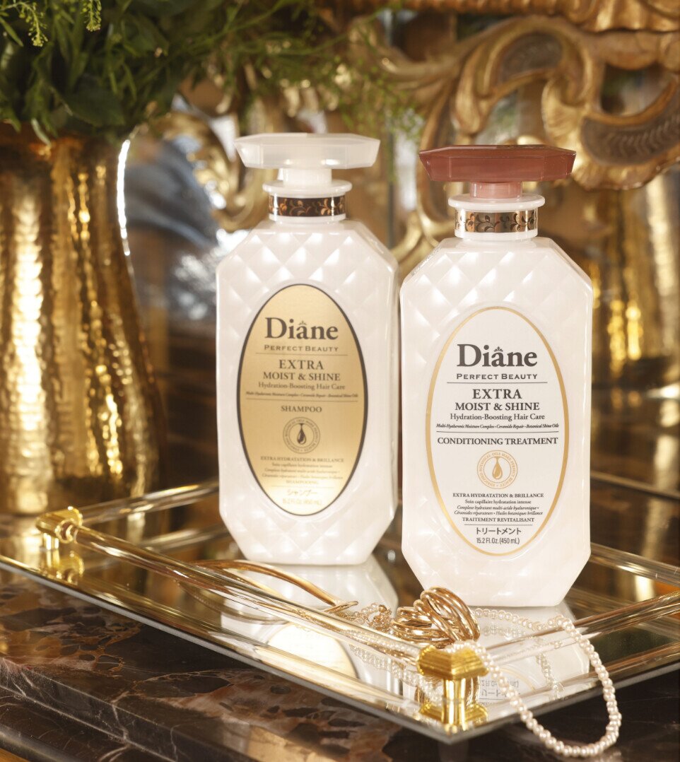 Extra Moist & Shine Shampoo and Conditioning Treatment on a mirrored gold tray with pearls