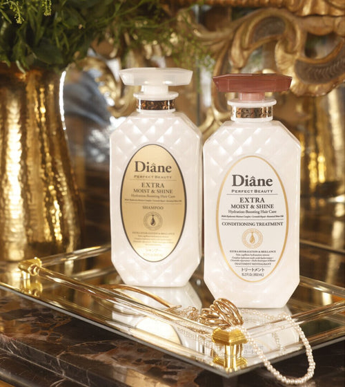 Extra Moist & Shine Shampoo and Conditioning Treatment on a mirrored gold tray with pearls
